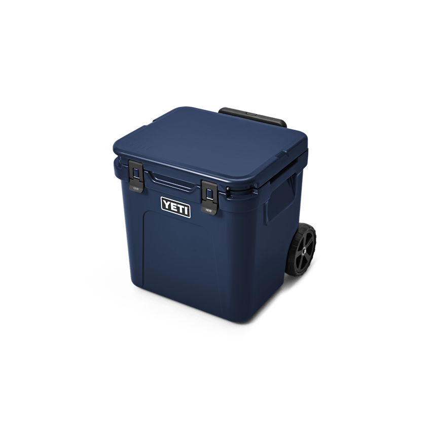 YETI Roadie® 48 Wheeled Cooler W 220022 site studio Hard Coolers Roadie 48 Navy 3qtr Front Handle Down 7794 Primary B 2400x2400 yeticoolershop.com