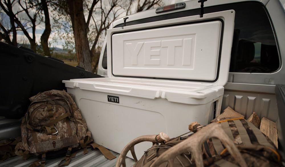 yeti tundra 60 premium cooling hard cooler on a pickup truck during a camping trip