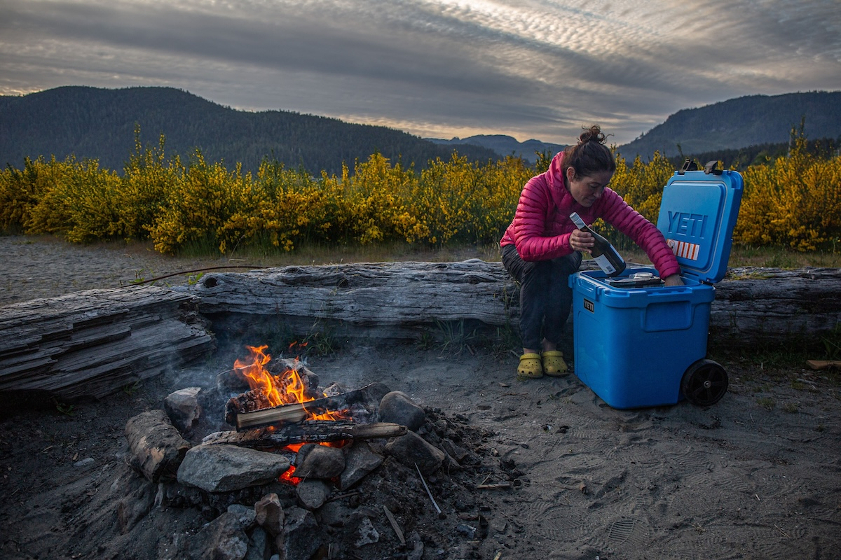 A rugged yeti sherpa cooler sitting on the back of an off-road vehicle during a mountain camping trip.