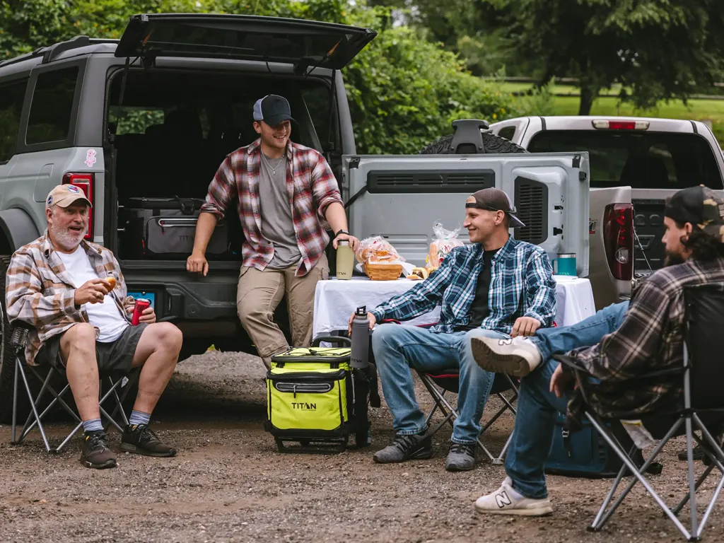 Friends using a yeti cooler grey for a tailgating event