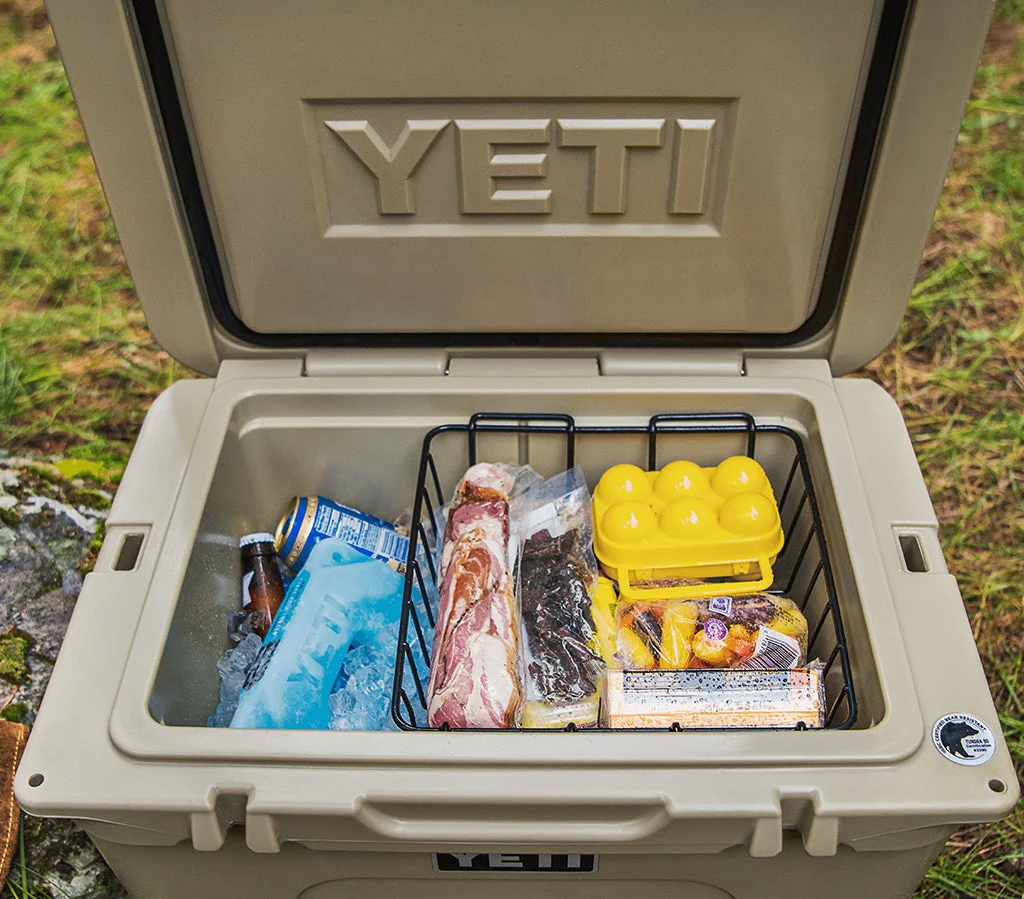 Organized outdoor gear store display showing internal cooler storage